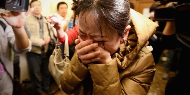 BEIJING, CHINA - MARCH 09: A relative of a passenger onboard Malaysia Airlines flight MH370 cries out at a local hotel where families are gathered on March 9, 2014 in Beijing, China. Malaysia Airline Flight MH370 from Kuala Lumpur to Beijing and carrying 239 onboard was reported missing after the crew failed to check in as scheduled while flying over the sea between Malaysia and Ho Chi Minh City in Vietnam, according to published reports. (Photo by Feng Li/Getty Images)