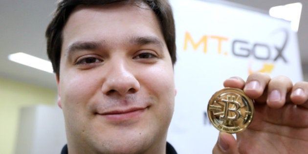 Mark Karpeles, chief executive officer of Tibanne Co., poses for a photograph with a bitcoin in the office operating the Mt.Gox K.K. bitcoin exchange in Tokyo, Japan, on Thursday, April 25, 2013. Bitcoin digital currency, which carries the unofficial ticker symbol of BTC, was unveiled in 2009 by an unidentified programmer, or group of programmers, under the name of Satoshi Nakamoto. Supply is capped at 21 million Bitcoins and managed by a software algorithm embedded into the digital currency?s design, rather than a monetary authority such as a central bank. Photographer: Tomohiro Ohsumi/Bloomberg via Getty Images