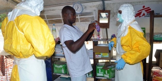 Members of Doctors Without Borders (MSF) put on protective gear at the isolation ward of the Donka Hospital, on July 23, 2014 in Conakry. A Liberian man has been hospitalised in Lagos with Ebola-like symptoms, but it is not yet clear if he is infected with the killer virus, Nigerian officials said on July 24. Ebola first emerged in 1976 in what is now the Democratic Republic of Congo, and is named after a river in that country. AFP PHOTO / CELLOU BINANI (Photo credit should read CELLOU BINANI/AFP/Getty Images)