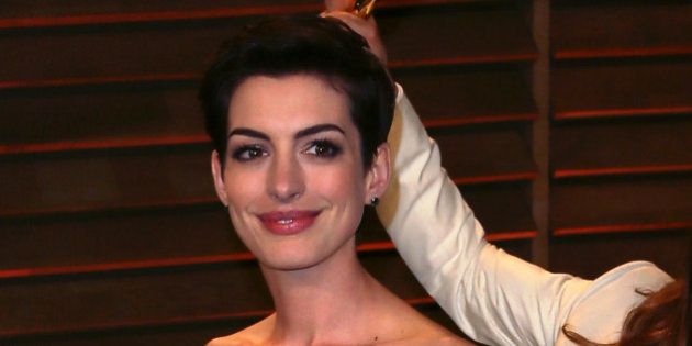 WEST HOLLYWOOD, CA - MARCH 02: Actor Jared Leto photobombs actress Anne Hathaway at the 2014 Vanity Fair Oscar Party hosted by Graydon Carter on March 2, 2014 in West Hollywood, California. (Photo by David Livingston/Getty Images)