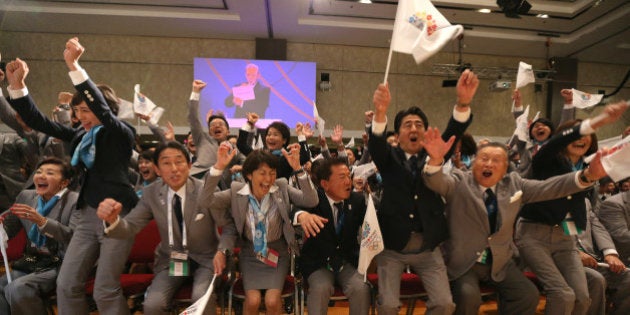 Japanese Prime Minister Shinzo Abe (3-R) celebrates alongside Tokyo 2020 delegation members after IOC president Jacques Rogge announced the Japanese capital to be the winner of the bid to host the 2020 Summer Olympic Games, during the 125th session of the International Olympic Committee (IOC), in Buenos Aires, on September 7, 2013. The three cities bidding to host the 2020 Summer Olympics -- Madrid, Istanbul and Tokyo -- delivered their final presentations ahead of the expected tight vote by the IOC, though Madrid was eliminated from the race moments after, in the first round of voting. AFP PHOTO / YAN WALTON (Photo credit should read YAN WALTON/AFP/Getty Images)