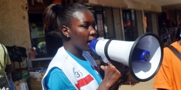 A member of the Guinean Red Cross uses a megaphone to give information concerning the Ebola virus during an awareness campaign on April 11, 2014 in Conakry. Guinea has been hit by the most severe strain of the virus, known as Zaire Ebola, which has had a fatality rate of up to 90 percent in past outbreaks, and for which there is no vaccine, cure or even specific treatment. The World Health Organization (WHO) has described west Africa's first outbreak among humans as one of the most challenging since the virus emerged in 1976 in what is now the Democratic Republic of Congo. AFP PHOTO / CELLOU BINANI (Photo credit should read CELLOU BINANI/AFP/Getty Images)