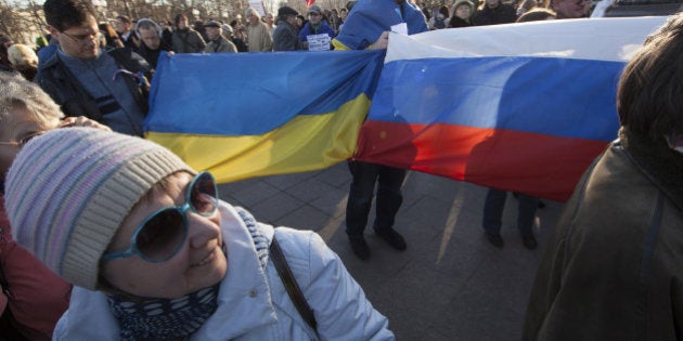 MOSCOW, RUSSIA - MARCH 10: Russian opposition activists hold Ukrainian and Russian flags during an anti-war rally on March 10, 2014 in Moscow, Russia. Dozens of anti-Putin activists gathered in central Moscow to protest against Russian President Vladimir Putin's policies on Ukraine and Crimea. (Photo by Sasha Mordovets/Getty Images)