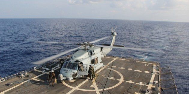 GULF OF THAILAND - MARCH 9: In this handout provided by the U.S. Navy, a U.S. Navy MH-60R Sea Hawk helicopter from Helicopter Maritime Strike Squadron (HSM) 78, Det 2, assigned to the guided-missile Destroyer USS Pinckney (DDG 91), lands aboard Pinckney during a crew swap before returning on task in the search and rescue for the missing Malaysian airlines flight MH370 on March 9, 2013 at sea in the Gulf of Thailand. The flight had 227 passengers from 14 nations, mainly China, and 12 crew members. According to the Malaysia Airlines website, three Americans, including one infant, were also aboard. (Photo by Senior Chief Petty Officer Chris D. Boardman/U.S. Navy via Getty Images)