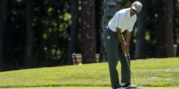 US President Barack Obama prepares to putt on the first green as he plays golf at the Farm Neck Golf Club at Martha's Vineyard, Massachusetts, on August 9, 2014, on the first day of the president's yearly summer vacation on the island. AFP PHOTO/Nicholas KAMM (Photo credit should read NICHOLAS KAMM/AFP/Getty Images)
