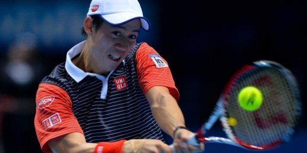 Japan's Kei Nishikori returns to Spain's David Ferrer during their Group B singles match on day five of the ATP World Tour Finals tennis tournament in London on November 13, 2014. AFP PHOTO/GLYN KIRK (Photo credit should read GLYN KIRK/AFP/Getty Images)