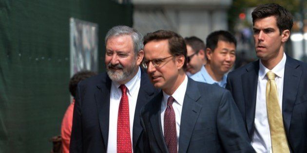 Attorneys Carmine Boccuzzi (C) and Jonathan Blackman (L) arrive at the US Federal Courthouse August 1, 2014 in New York where talks continue into the Argentinian debt. Argentina said there was little hope of resolving its damaging debt dispute at a US court hearing Friday, accusing the judge of bias as repercussions from its partial default continued to mount. AFP PHOTO/Stan HONDA (Photo credit should read STAN HONDA/AFP/Getty Images)