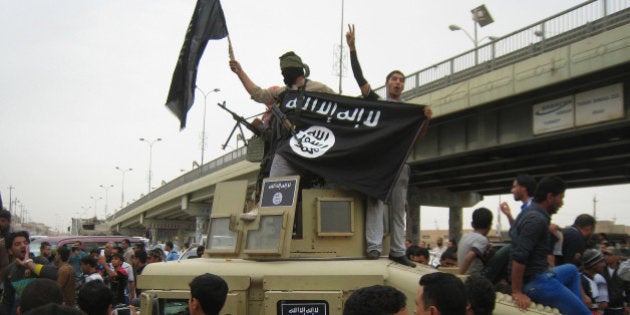 FILE - in this Sunday, March 30, 2014, file photo, Islamic State group militants hold up their flag as they patrol in a commandeered Iraqi military vehicle in Fallujah, 40 miles (65 kilometers) west of Baghdad, Iraq. The fall of Fallujah in January 2014 started the Islamic State group's dramatic blitz across Iraq. In June, the extremists captured Iraq's second-largest city, Mosul, then swept south toward Baghdad in a march that put almost all the Sunni-majority regions of northern and western Iraq into its hands. The Iraqi military crumbled, with troops often dropping their weapons and fleeing. (AP Photo, File)