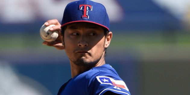 SURPRISE, AZ - MARCH 05: Yu Darvish #11 of the Texas Rangers pitches in the first inning against the Kansas City Royals at Surprise Stadium on March 5, 2015 in Surprise, Arizona. (Photo by Lisa Blumenfeld/Getty Images)