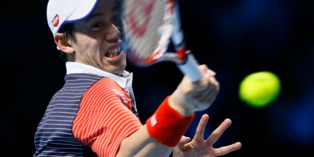 Japanâs Kei Nishikori plays a return to Spain's David Ferrer during their ATP World Tour tennis finals match at the O2 arena in London, Thursday, Nov. 13, 2014. (AP Photo/Kirsty Wigglesworth)