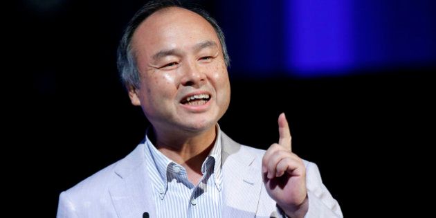 Masayoshi Son, chairman and chief executive officer of SoftBank Corp., gestures as he speaks at SoftBank World 2014 in Tokyo, Japan, on Tuesday, July 15, 2014. As Son pushes for a takeover of T-Mobile US Inc., the Japanese billionaire is asking banks to commit financing for a longer-than-usual amount of time, underscoring the intense regulatory review he faces. Photographer: Kiyoshi Ota/Bloomberg via Getty Images