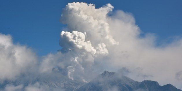A cloud of volcanis ash rise from Mount Ontake seen from Gifu prefecture on September 28, 2014. More 30 hikers were found in 'cardiac arrest' near the peak of the erupting volcano in Japan police said. The eruption of the 3,067-metre (10,121-foot) Mount Ontake happened around midday, the meteorological agency said. AFP PHOTO / KAZUHIRO NOGI (Photo credit should read KAZUHIRO NOGI/AFP/Getty Images)