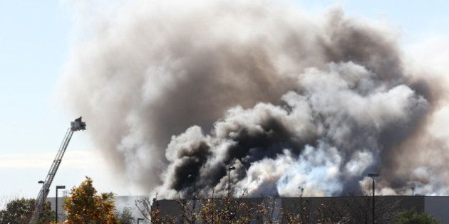 Smoke billows from a building at at Mid-Continent Airport in Wichita, Kan., Thursday, Oct. 30, 2014 shortly after a Beechcraft King Air B200 crashed into the building, killing several people, including the pilot. (Brian Corn/Wichita Eagle/MCT via Getty Images)