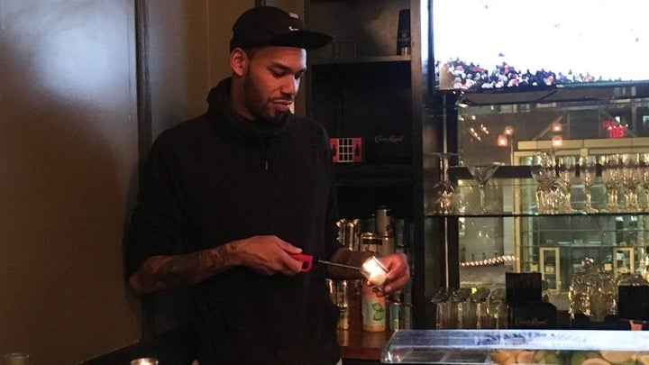 Tim Slayton, 36, lights a candle at Marvin, a 14th Street bar in Washington, D.C. The U.S. Census Bureau knows young urban re