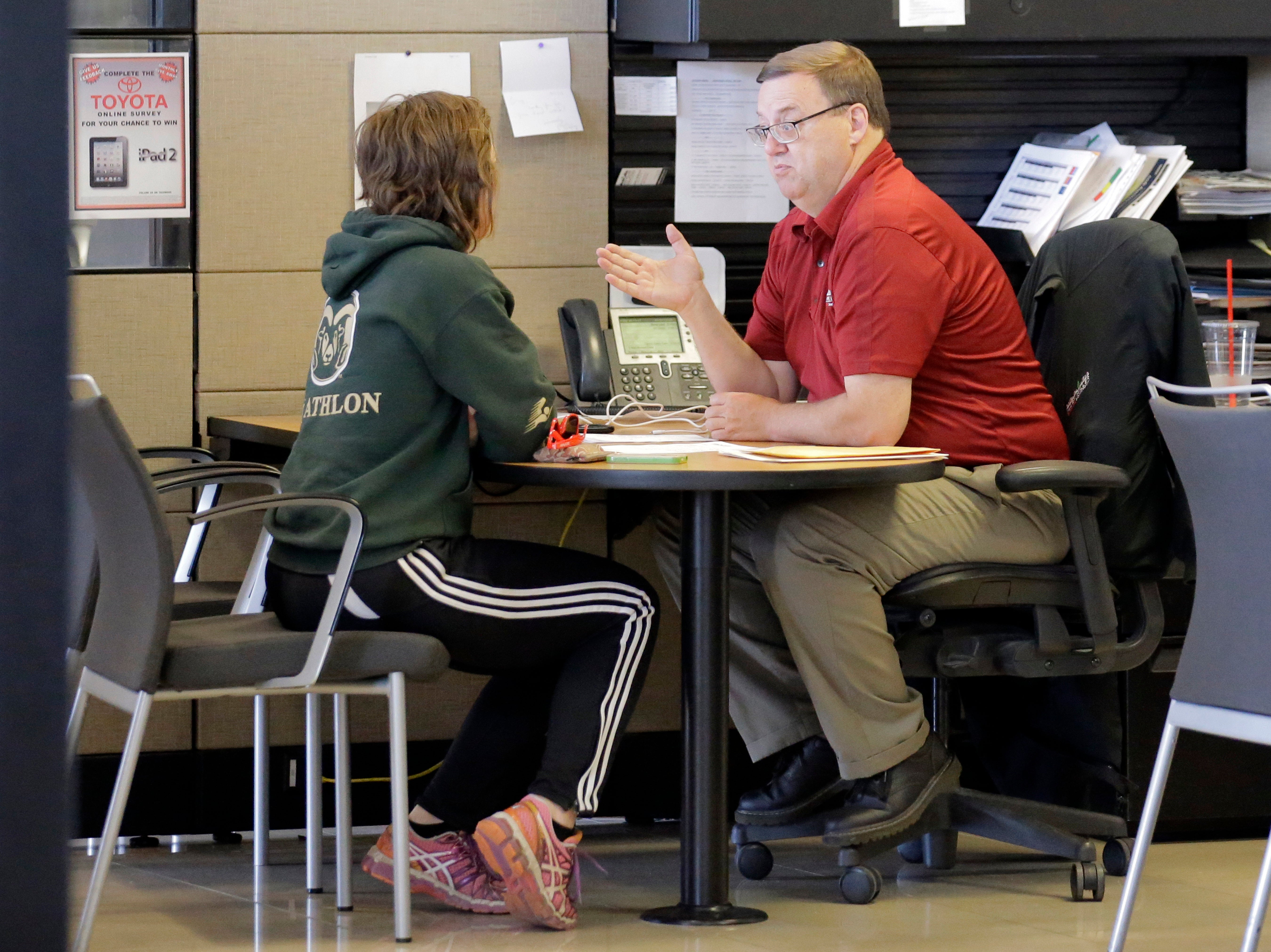 Vehicle shopper Mary Jean Jones speaks with Mark Miller Toyota salesman Doug Lund Tuesday, June 13, 2017, in Salt Lake City. (AP Photo/Rick Bowmer)