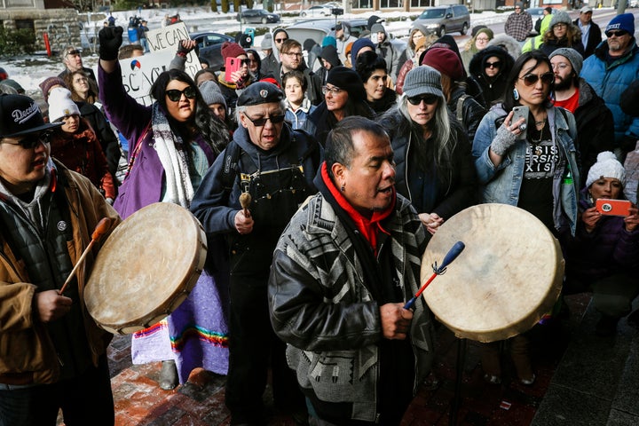 A protester leads a Native American prayer with a traditional drum outside the Catholic Diocese of Covington, Kentucky, on Ja