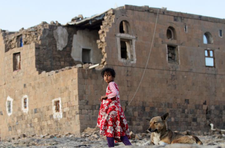 A girl walks near her house destroyed in an airstrike carried out by the Saudi-led coalition in Faj Attan village, Sanaa, Yemen.
