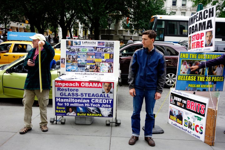 Lyndon LaRouche supporters with signs calling for impeaching President Obama and firing Speaker of the House, John Boehner in