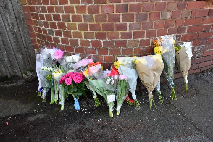 Floral tributes left outside Cowick Lane, Exeter, where the bodies of twins Dick and Roger Carter, aged 84, were discovered on Tuesday