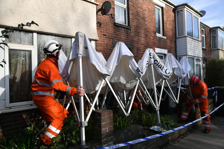Members of fire and rescue erect a gazebo outside the address in Bonhay Road