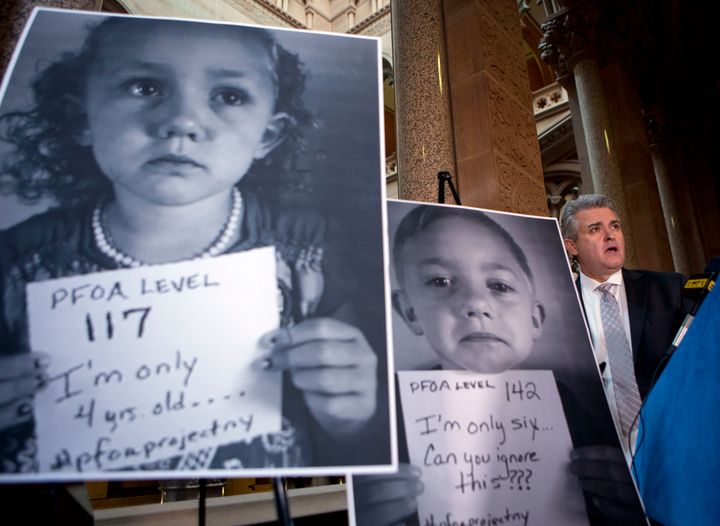 New York state Assemblyman Steve McLaughlin, a Republican, shows photos of children from Hoosick Falls, N.Y., whose blood has high levels of toxic PFOA.