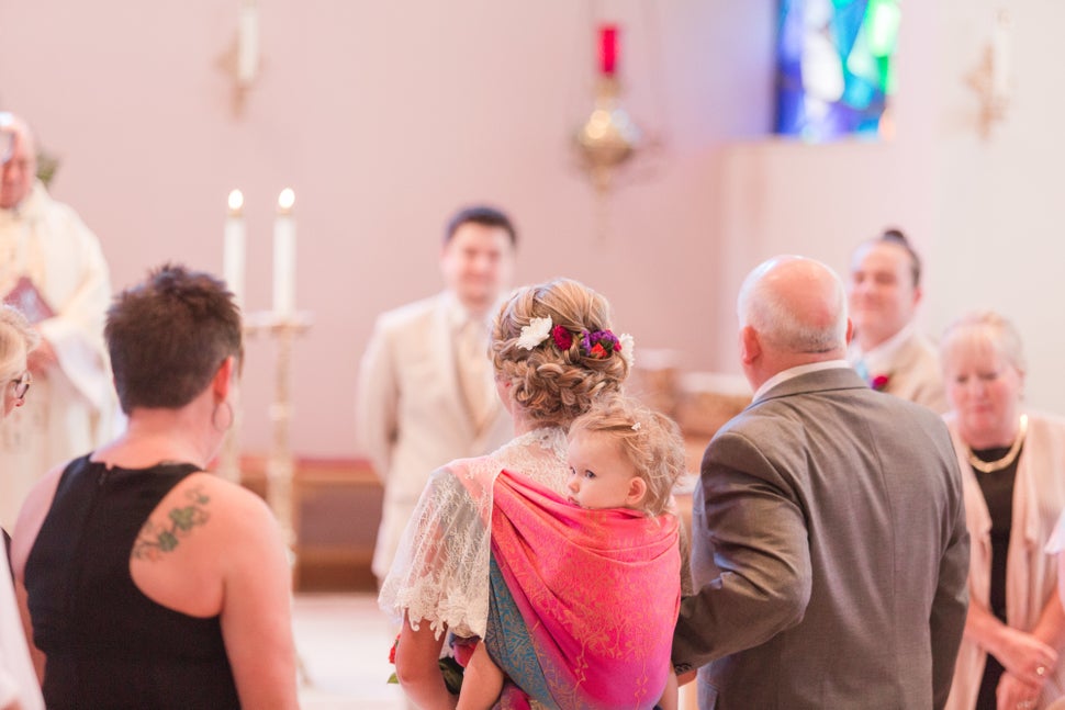 Dalton Mort wore her toddler in a wrap throughout her wedding ceremony -- a "fantastic idea" that led to great photos, said photographer Laura Schaefer.