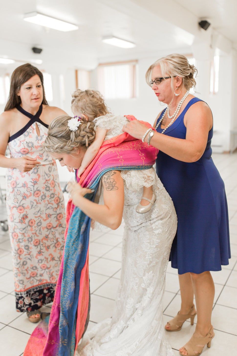 Laura Schaefer of Fire and Gold Photography said snapping pics of Mort getting her toddler wrapped was reminiscent of photos of brides putting on their veils.
