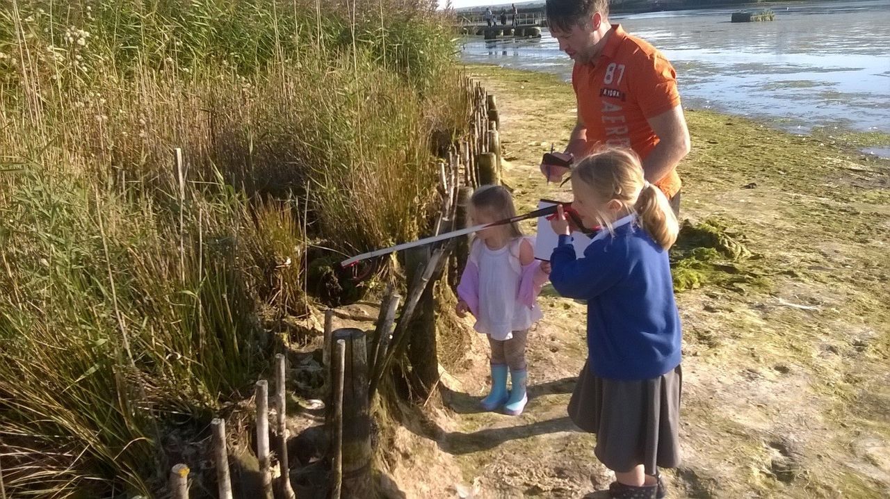 Paul and his daughters doing some litter picking in a drained lake in the park.