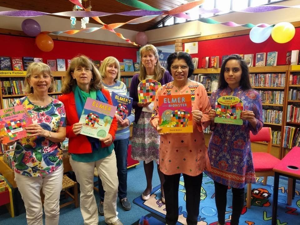 A group of volunteers all looking colourful on Elmer Day – a special event organised for children at the library. Chris is the third from the right.