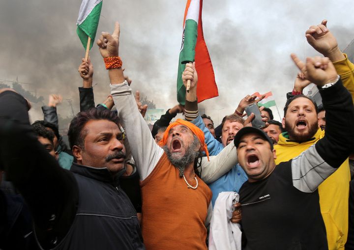 People shout slogans during a protest against the attack on a bus carrying CRPF personnel in Kashmir.