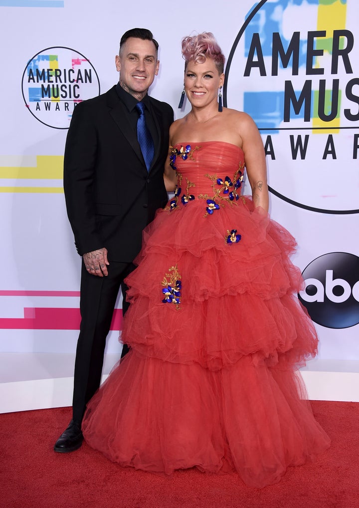 Carey Hart (left) and Pink arrive at the American Music Awards in November 2017 in Los Angeles. Pink spoke on "The Ellen DeGeneres Show" about the time she slashed Hart's tires.