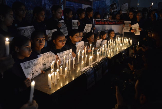 School students hold candles as they pay tribute to the CRPF personnel killed in Pulwama