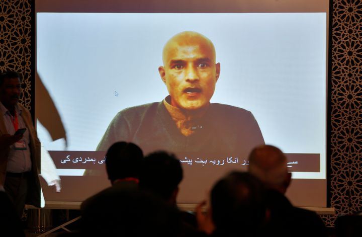 Pakistani journalists watch a video message of imprisoned Indian naval officer Kulbhushan Jadhav during a press conference in Islamabad, Pakistan, Dec. 25, 2017.