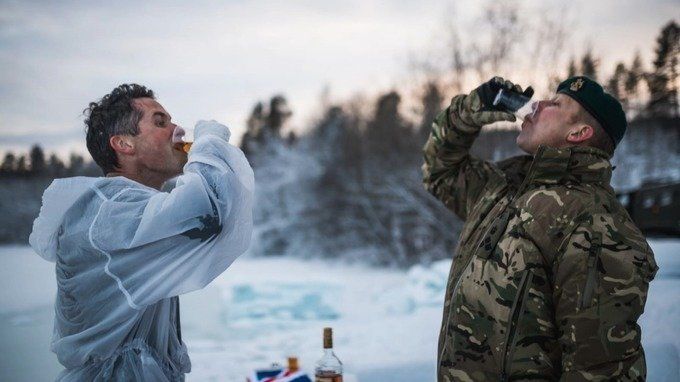 Williamson necking a shot of whisky after a particularly chilly exercise.