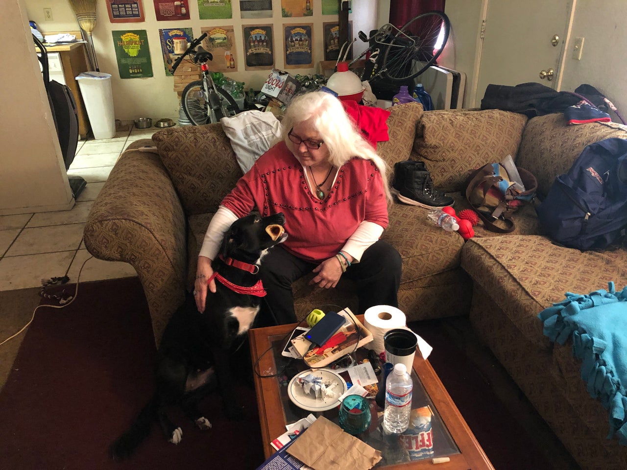 Jill David, with her dog, Ivy, has been sleeping on her son's sofa since losing her home to the Camp fire. — Chico, California, Feb. 11
