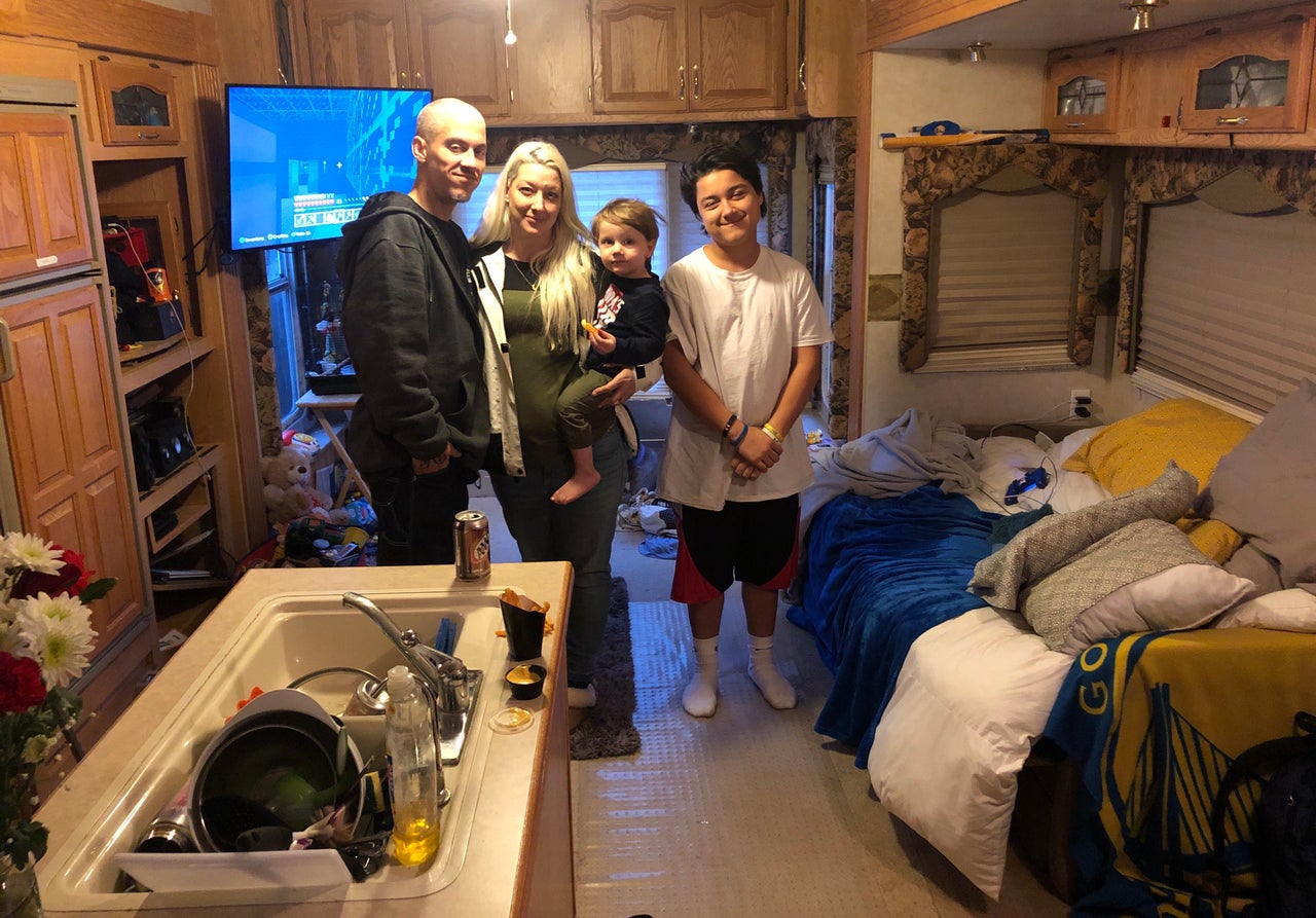 (From left) Jeremy, Kristine, Hayden and Ethan Alaways, in the trailer where they now live in her parents' yard, after losing their house in the Camp fire. — Oroville, California, Feb. 11