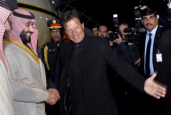 In this photo released by the Press Information Department, Pakistani Prime Minister Imran Khan, centre, greets Saudi Arabia's Crown Prince Mohammed bin Salman, left, upon his arrival at Nur Khan airbase in Rawalpindi, Pakistan, Feb. 17, 2019. 