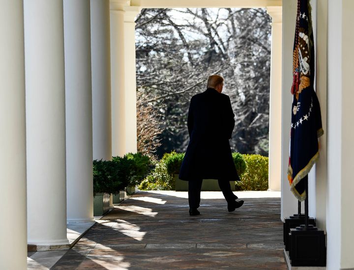 Trump walking back into the White House after announcing a national emergency last Friday.