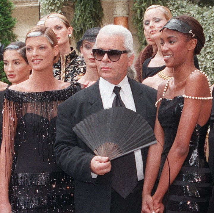 Karl Lagerfeld is surrounded by models during the closing of the Fall / Winter 1996-1997 fashion presentation in Paris.