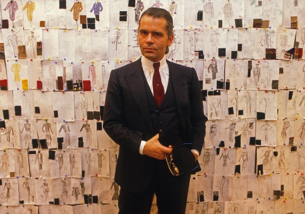 Lagerfeld photographed in front of his sketches at Chanel in 1984, the year after he was appointed as...