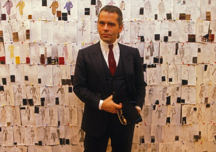 Lagerfeld photographed in front of his sketches at Chanel in 1984, the year after he was appointed as the brand's creative director. 