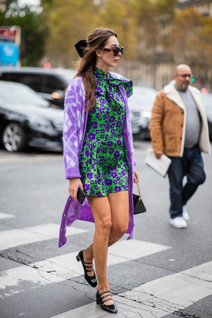 Style consultant Estelle Pigault wears a purple cardigan atop a green floral dress in Paris.