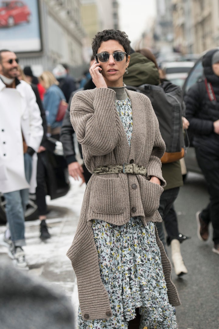 Yasmin Sewell, vice president of style and creative at Farfetch, wears a floral dress wrapped in a belted, chunky cardigan in London.