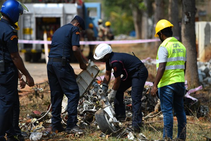 Officials seen trying to clear the debris of the crashed plane.