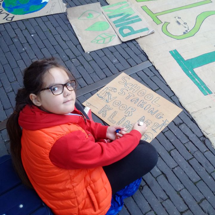 Lilly Platt making a placard reading "school strike for climate" at the Hague in the Netherlands. She ditches school every Friday to protest global inaction on climate change. 