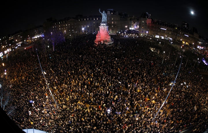 A photo, taken with a fish-eye lens, shows people attending a national gathering at Place de la Republique to protest the rise of anti-Semitic attacks in France on February 19, 2019. 