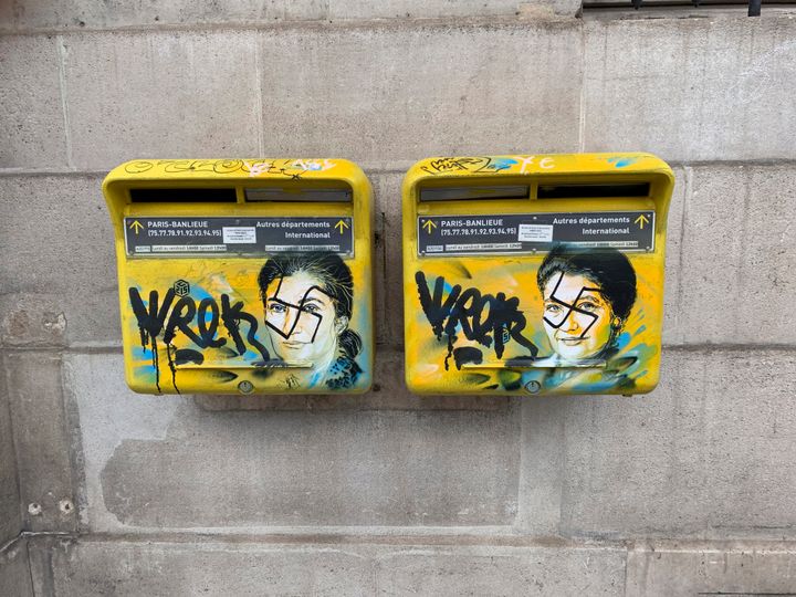 A photo taken on Monday, Feb. 11, 2019 shows mailboxes with swastikas covering the face of the late Holocaust survivor and renowned French politician, Simone Veil, in Paris, France. 
