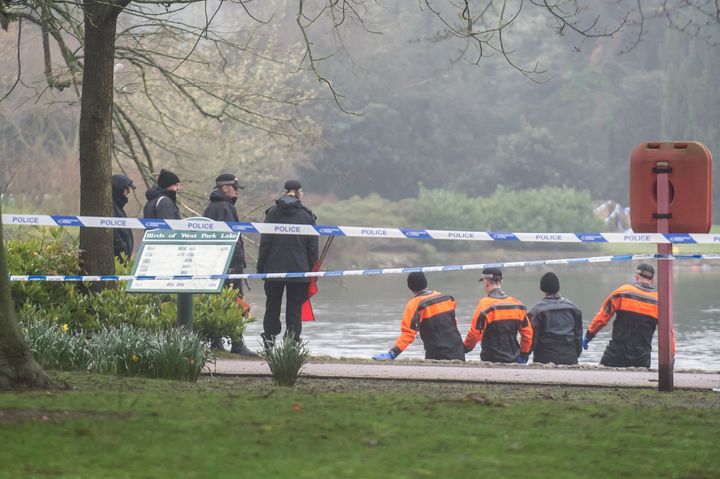 Officers combing the park's boating lake after the discovery of Viktorija's body 