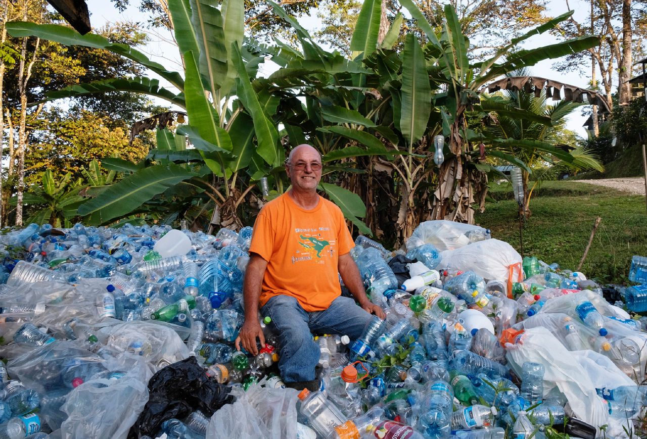 Bezeau sits on a pile of plastic bottles, which are exchanged for 5 cents.