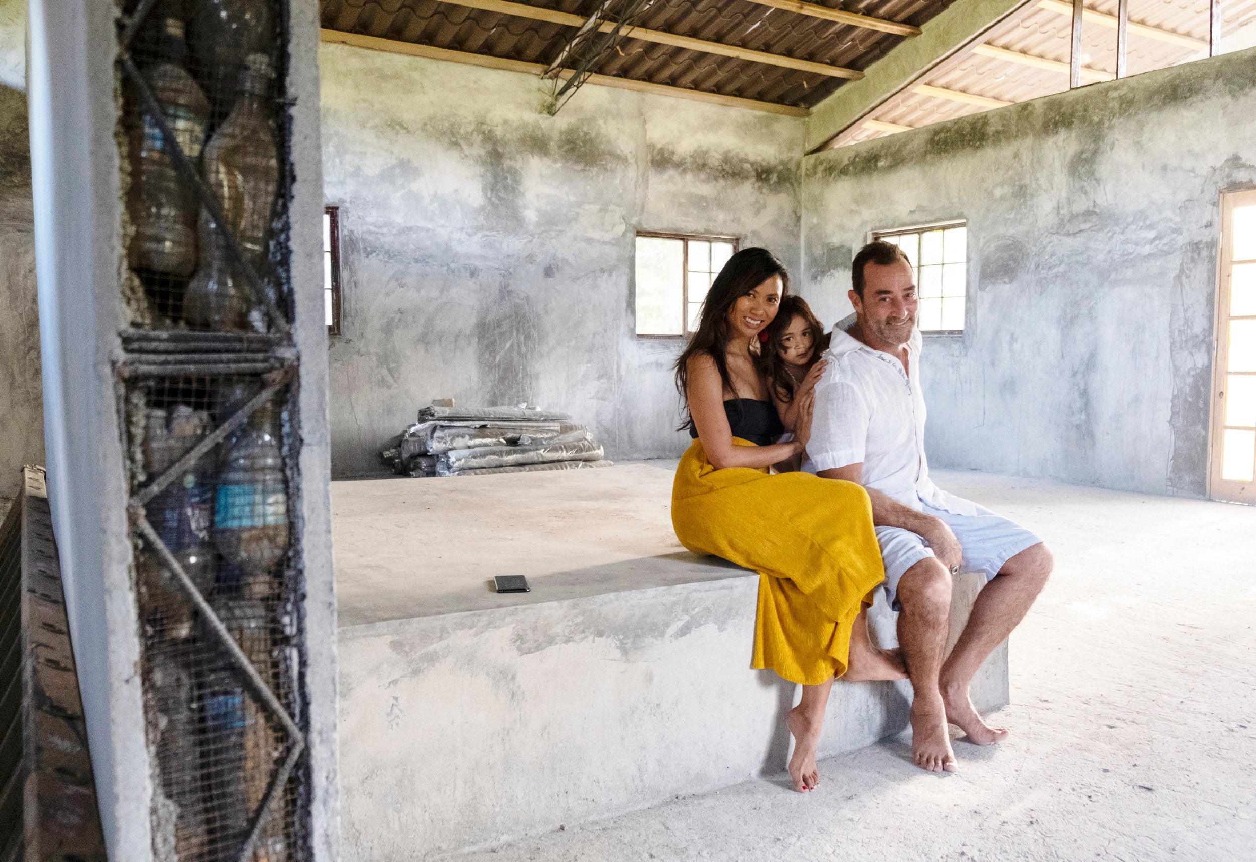 Jeff Catalano, Justine Catalano and daugther Jay, in their house made of plastic bottles on Isla Colón, Panama. The ho